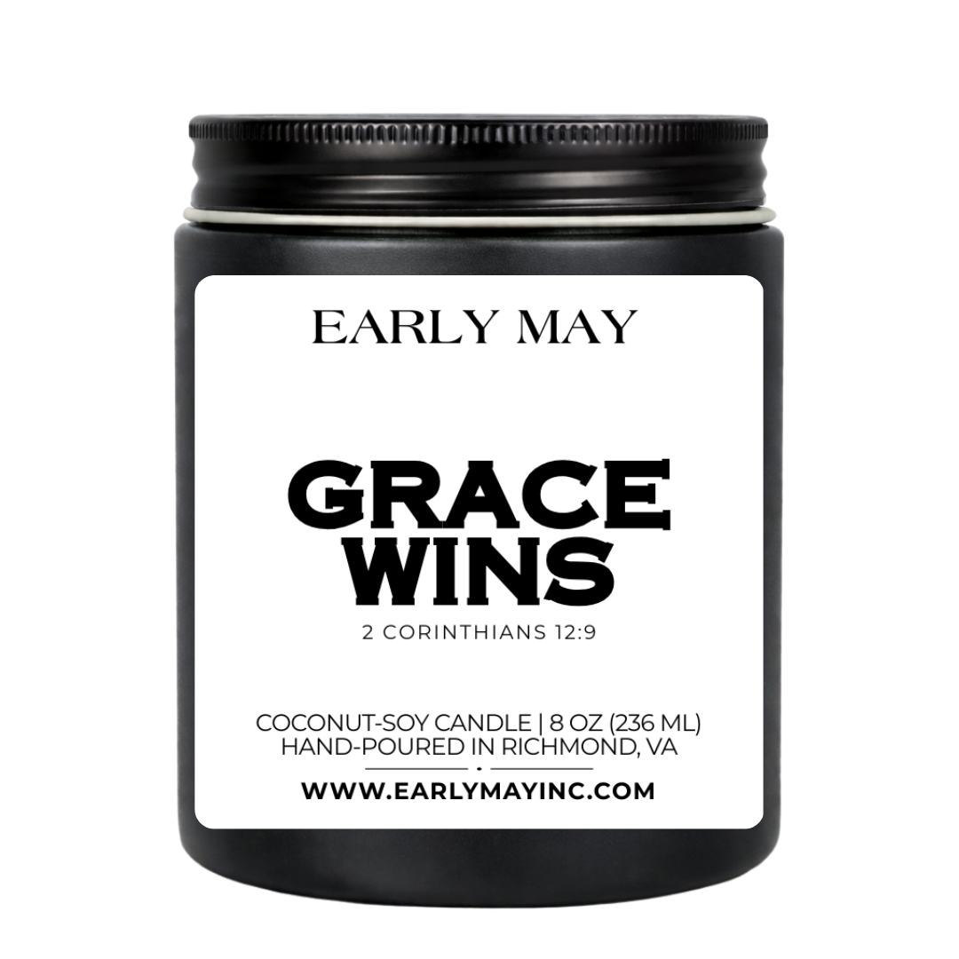 Black candle jar with 'Early May' branding and 'Grace Wins' text on a white background