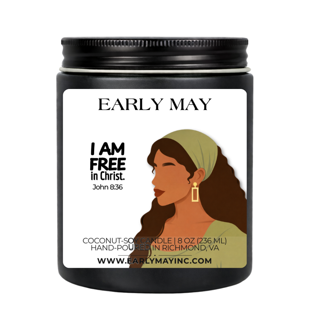 Black candle jar with a label featuring a woman's profile and text, on a white background.