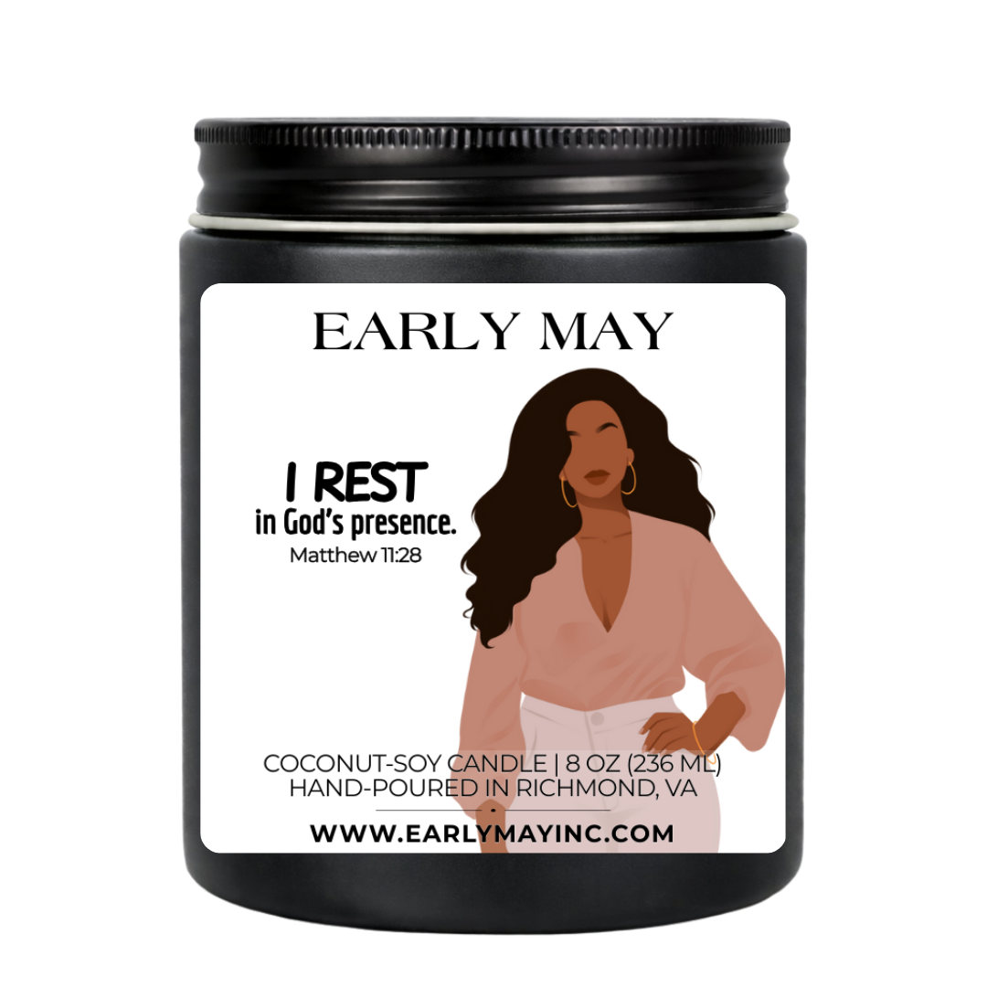 Black candle jar with a label featuring a woman and text, on a white background