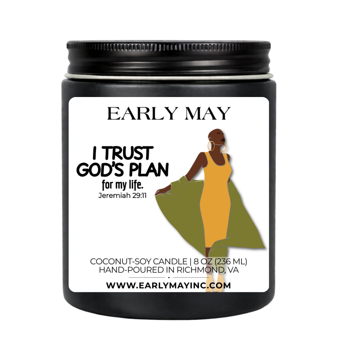 Black candle jar with a label featuring a woman and text, on a white background