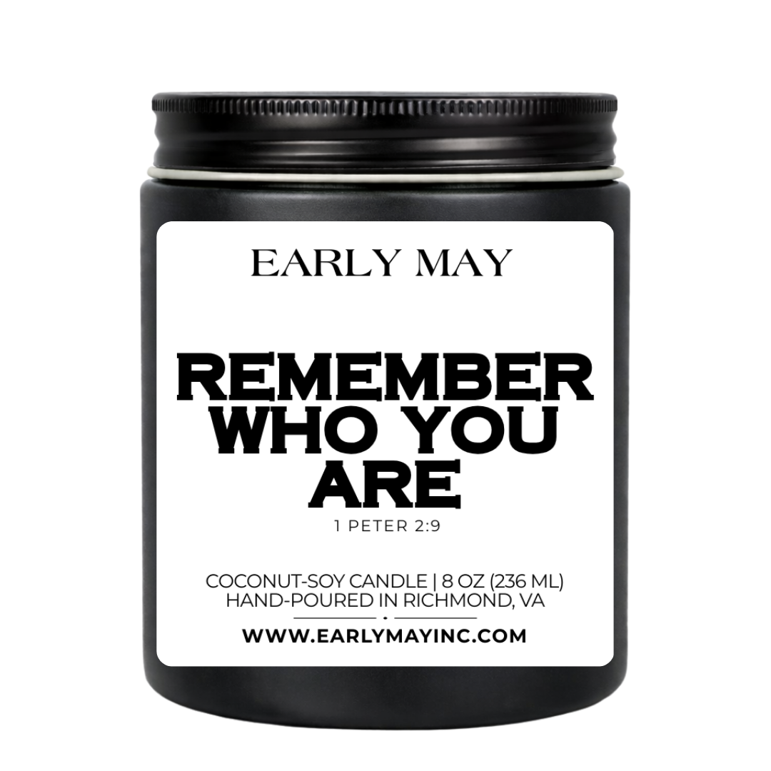Black candle jar with 'Early May' branding and motivational quote on a white background