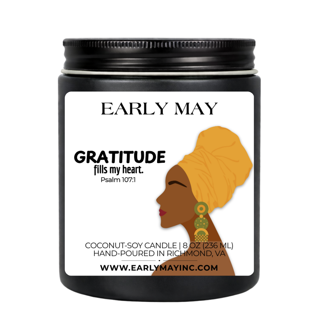 Black candle jar with a label featuring a woman's silhouette and 'Early May' branding.