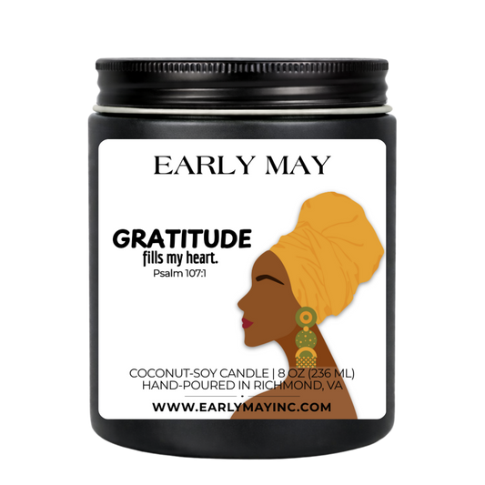 Black candle jar with a label featuring a woman's silhouette and 'Early May' branding.
