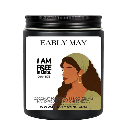 Black candle jar with a label featuring a woman's profile and text, on a white background.