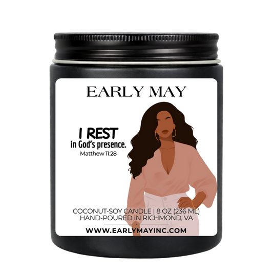 Black candle jar with a label featuring a woman and text, on a white background
