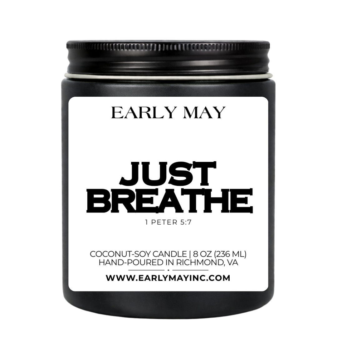 Black candle jar with 'Early May' branding and 'Just Breathe' text on a white background