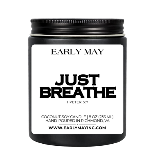 Black candle jar with 'Early May' branding and 'Just Breathe' text on a white background