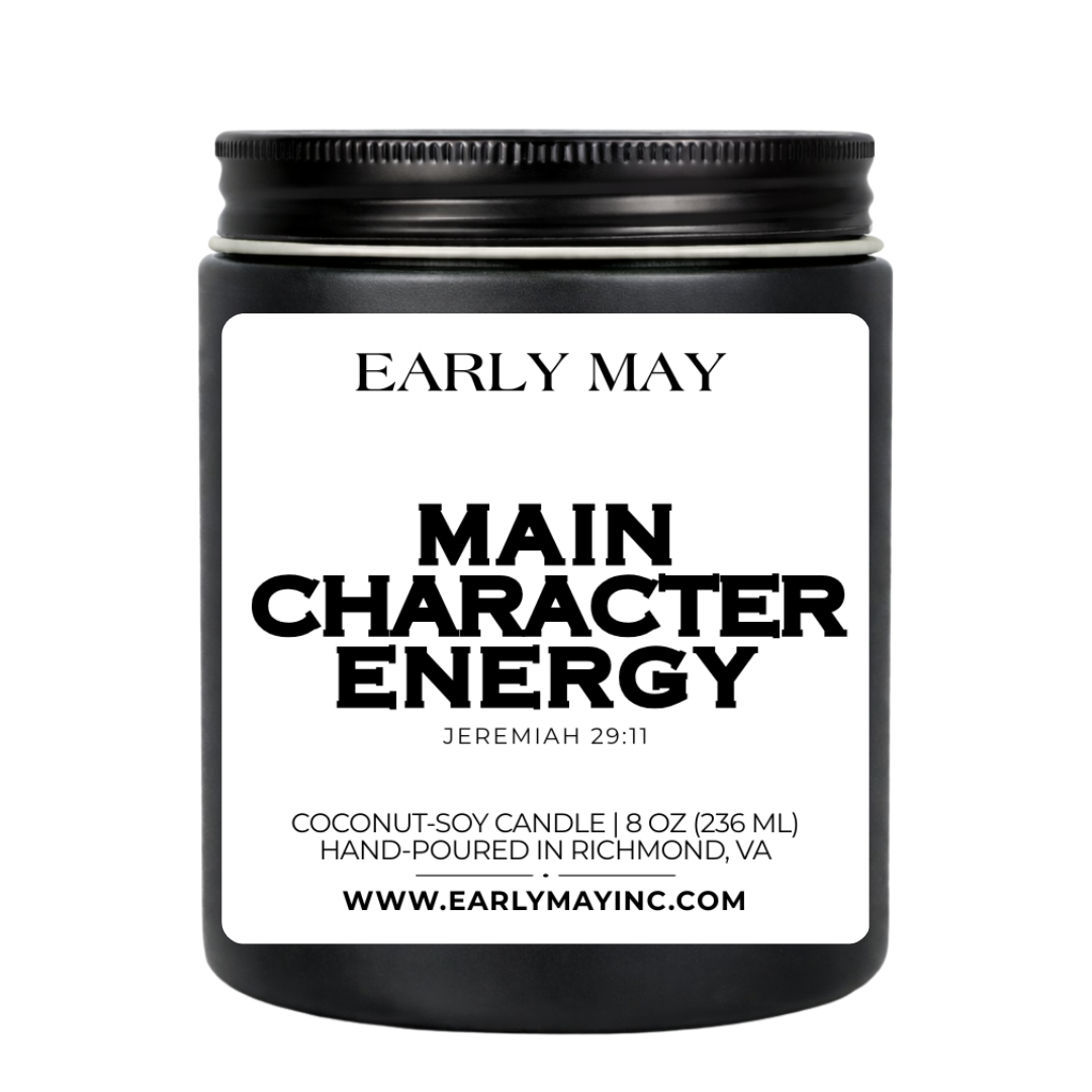 Black candle jar with 'Early May' branding and 'Main Character Energy' label on a white background