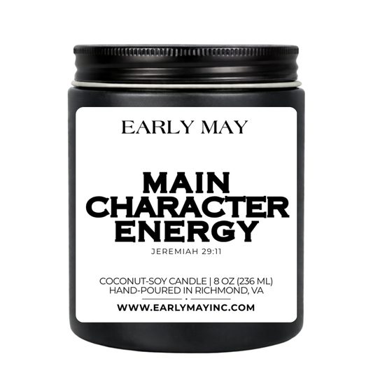 Black candle jar with 'Early May' branding and 'Main Character Energy' label on a white background